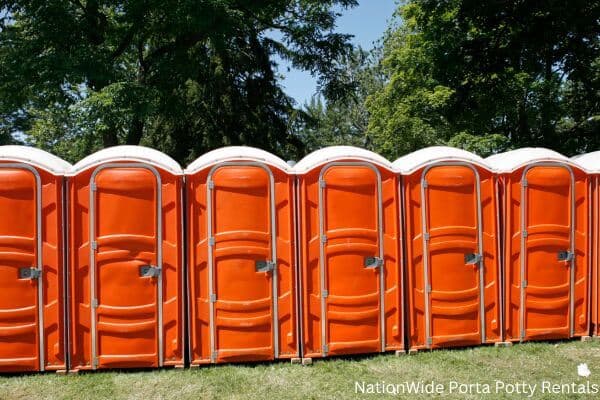 a lineup of clean and well-maintained portable loos for workers in New Salem, ND